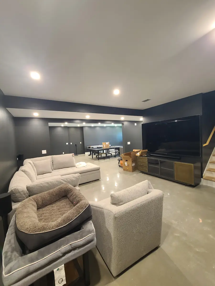 Basement Finishing — Finished living area with TV on the right