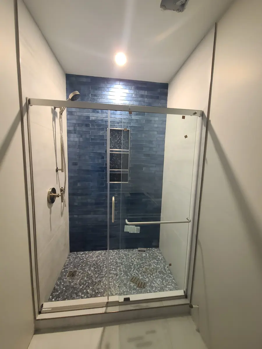 Basement Finishing — Sliding shower door and bathroom fixtures